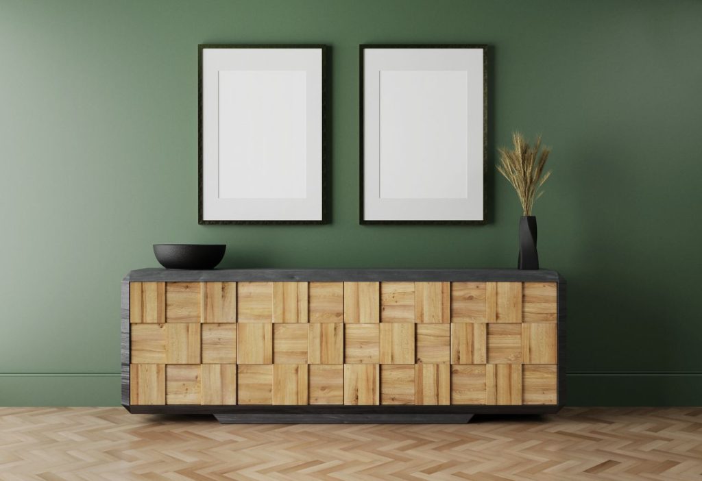 Geometric sideboard with green wall and two blank picture frames